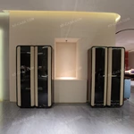 Rounded-Corner Dark Wood Wine Cabinet with Tinted Glass Doors Quilted Beige Upholstered Panels and Interior Shelving